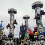LEGOLAND New York: A group of people are riding on a ride at an amusement park.